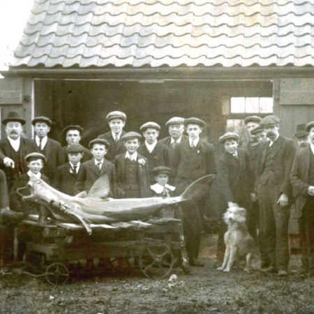 Locals with a large fish over 100 years ago in what is now the Three Horseshoes pub garden 